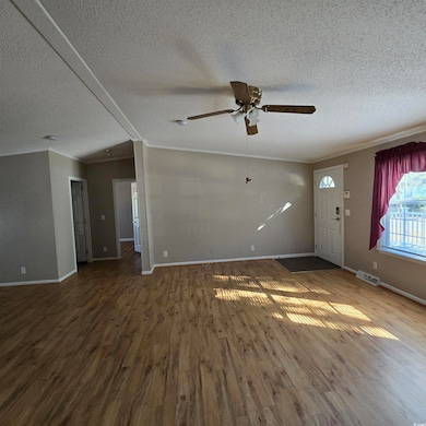 Unfurnished living room featuring crown molding, c