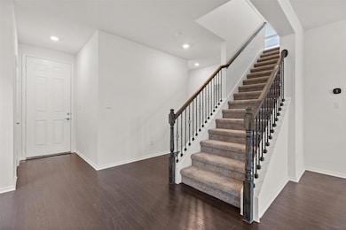 Stairway with baseboards, wood finished floors, a