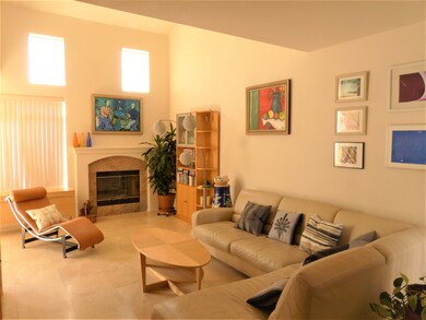 Living room with fireplace and vaulted ceilings.
