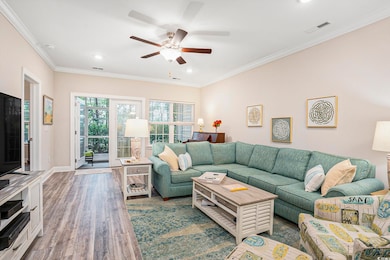 Living area with ornamental molding, wood finished floors, recessed lighting, and ceiling fan