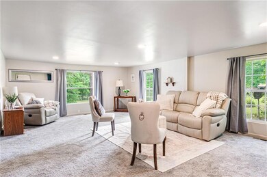 Living room with visible vents, baseboards, a weal