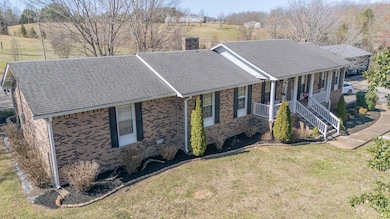 Single story home featuring covered porch, roof wi