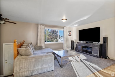 Living area with wood finished floors and a ceiling fan