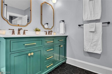 Bathroom with tile patterned flooring and dual bowl vanity