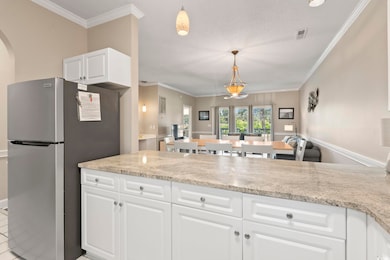 Kitchen with crown molding, freestanding refrigera