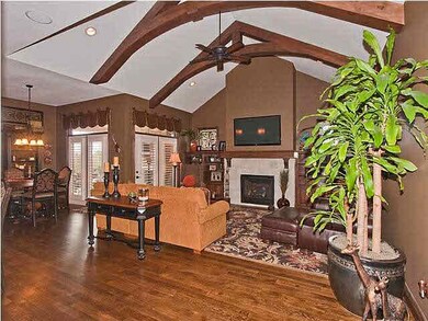 Hearth room features vaulted ceilings with wood be