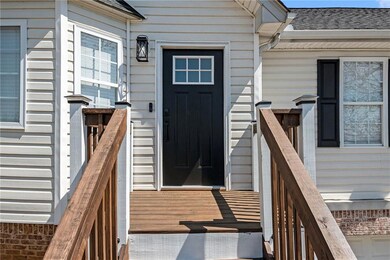 Doorway to property with roof with shingles