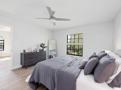 Bedroom with ceiling fan and light hardwood / wood-style flooring