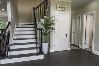 Staircase featuring wood finished floors, crown molding, and recessed lighting