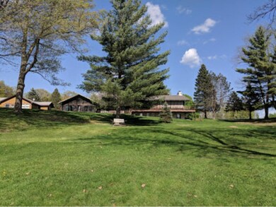 View of cabin with the lake behind in this photo.