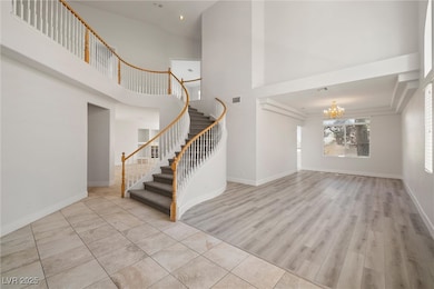 Entryway with an inviting chandelier, stairs, visi