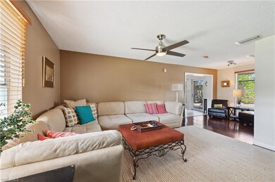 Living room featuring ceiling fan, a textured ceil
