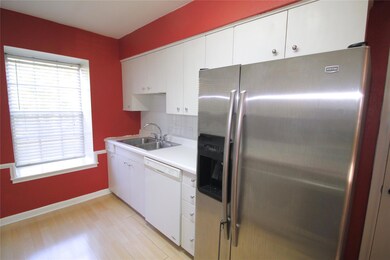 Kitchen featuring white cabinets, stainless steel 