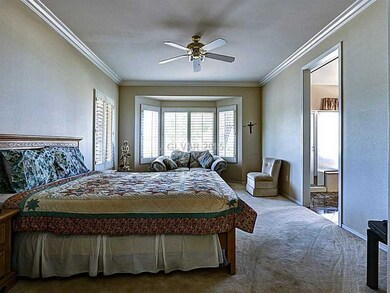 Master Bedroom. Master Bedroom with Bay Window & Custom Shutters, Crown Molding, Ceiling Fan, Carpeting and In Suite Bath.