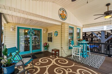 Wooden terrace featuring ceiling fan and a porch