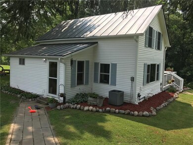 Entry way from garage, newer A/C, Fresh landscaping and plenty of perennials. New Metal roof 2020