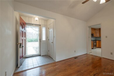 Foyer with ceiling fan, light hardwood / wood-style floors, and vaulted ceiling