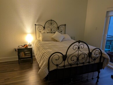 Bedroom featuring wood finished floors and a text