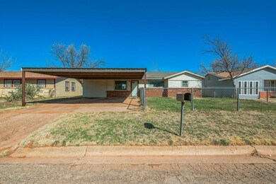 Ranch-style home with brick siding, a front yard, 