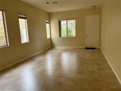 Empty room with light tile patterned floors
