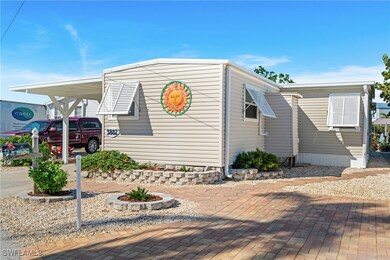 Side of property featuring an extra paver driveway