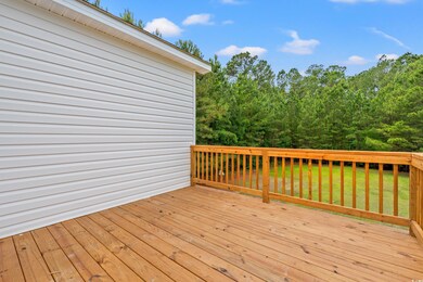 Wooden deck featuring a lawn