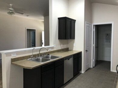 Kitchen looking  into living area toward front doo