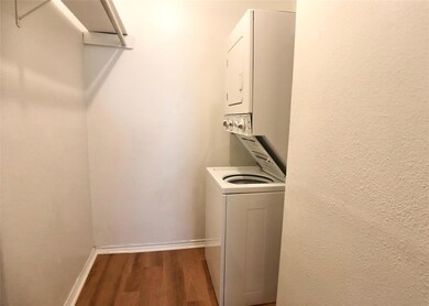 Laundry room featuring stacked washer and clothes