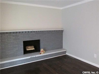 Family Room. family room with fireplace and hardwoods.....slider off familyroom leads to 3 seasonroom