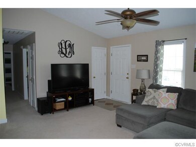 Living room with vaulted ceiling.