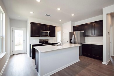 Kitchen with stainless steel appliances, a sink, 