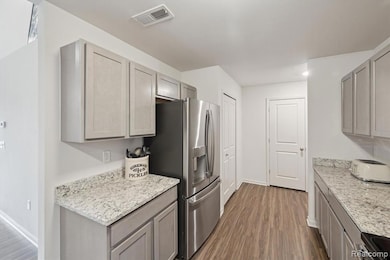 Granite & luxury vinyl floors throughout kitchen.