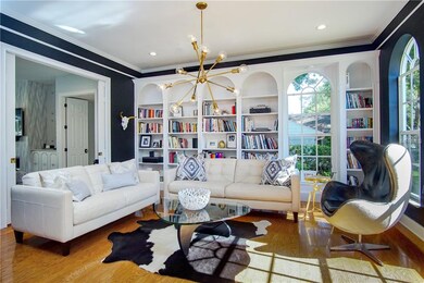 Living room off of foyer, complete with custom lighting and elegant pocket doors.