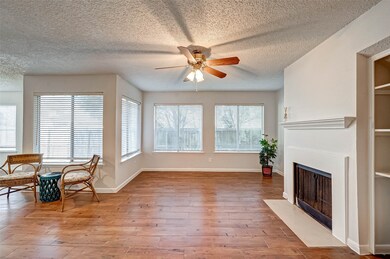 Living room featuring wood burning fireplace and l