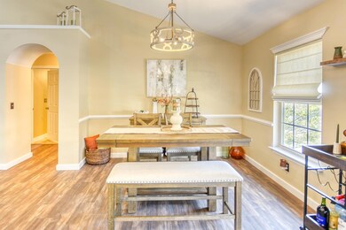 Dining room featuring lofted ceiling, hardwood / w