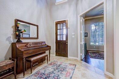 Formal entry with 17ft ceiling next to office/study that's currently being used as a TV/game room.