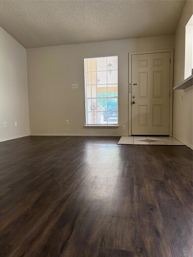 Entryway with wood finished floors, baseboards, a