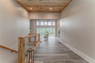 Aerial view of a heavily wooded area and a nearby body of water