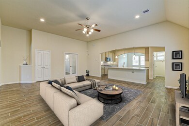 Virtually Staged.This elegant living space with high ceilings, wood tile floor gives this room a cozy ambience. The open concept offers indoor entertaining for you and your guests.