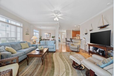 Living room with ceiling fan with notable chandeli