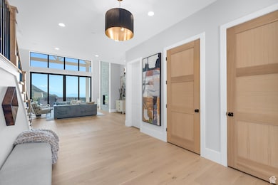 Bedroom with light wood finished floors and recessed lighting