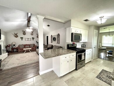 Updated custom kitchen with breakfast bar into family room, granite counter tops and stainless appliances
