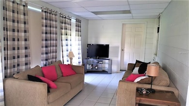 Living Room has tiled flooring & large windows to 