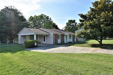 This ranch has carport with storage room too