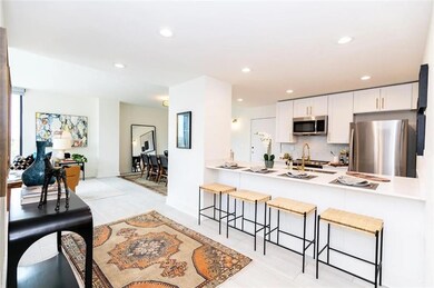 Kitchen with light tile patterned floors, white ca