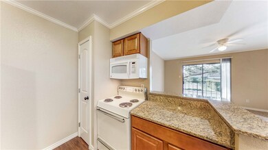 Kitchen featuring a ceiling fan, brown cabinetry,