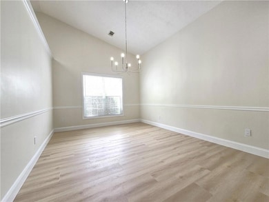 Spare room with visible vents, baseboards, high va