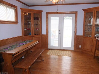 Formal dining room with hardwood floor, crown mold