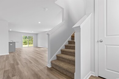 Staircase featuring wood-type flooring