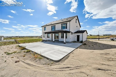 Rear view of property featuring stucco siding